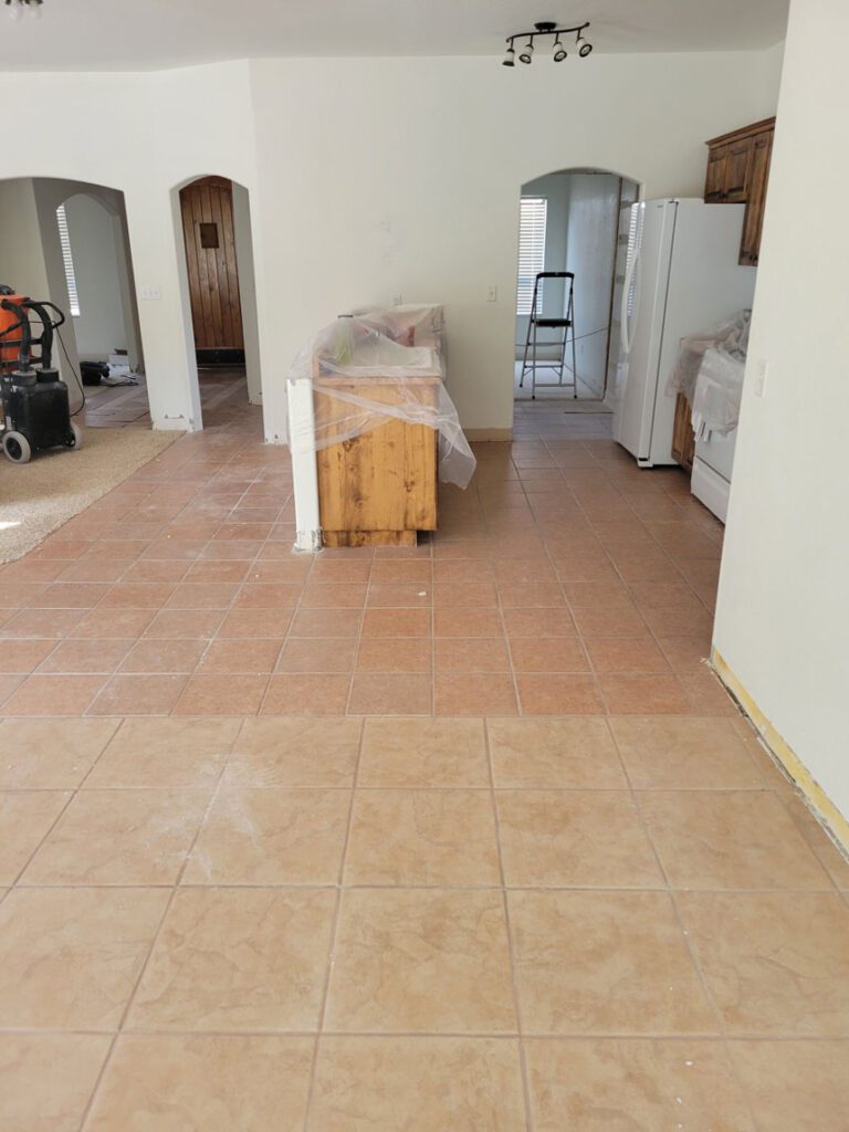 Modern kitchen featuring white refrigerator and tile flooring.