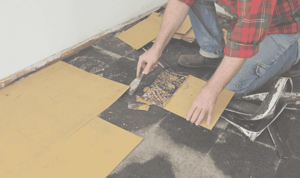 A man is engaged in cutting a floor with a knife, illustrating innovative techniques in demolition work.